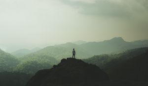 Preview wallpaper silhouette, mountains, fog, peak, loneliness, freedom