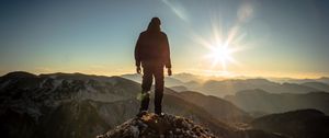 Preview wallpaper silhouette, mountains, sunlight, peaks, dawn, glare