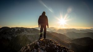 Preview wallpaper silhouette, mountains, sunlight, peaks, dawn, glare