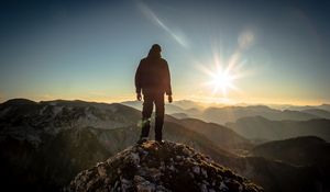 Preview wallpaper silhouette, mountains, sunlight, peaks, dawn, glare