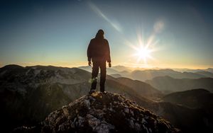 Preview wallpaper silhouette, mountains, sunlight, peaks, dawn, glare