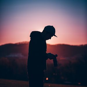 Preview wallpaper silhouette, photographer, dark, sunset, twilight, evening