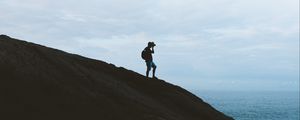 Preview wallpaper silhouette, photographer, hill, shore