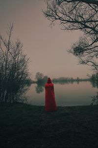 Preview wallpaper silhouette, red, cloak, lake, shore