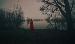 Preview wallpaper silhouette, red, cloak, lake, shore