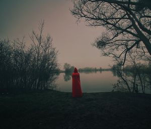 Preview wallpaper silhouette, red, cloak, lake, shore