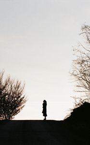 Preview wallpaper silhouette, road, dark, dusk, hill, trees