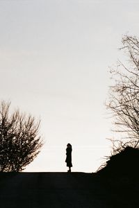 Preview wallpaper silhouette, road, dark, dusk, hill, trees