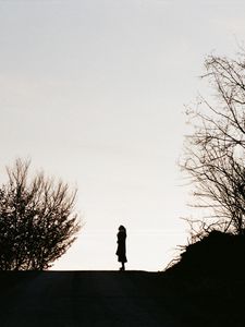 Preview wallpaper silhouette, road, dark, dusk, hill, trees