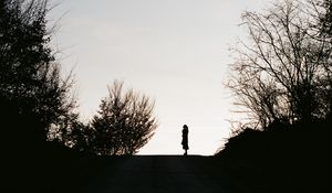 Preview wallpaper silhouette, road, dark, dusk, hill, trees