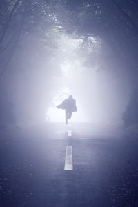 Preview wallpaper silhouette, road, fog, run, alone