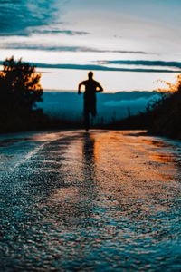 Preview wallpaper silhouette, road, running, asphalt, wet