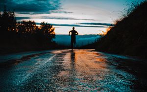 Preview wallpaper silhouette, road, running, asphalt, wet