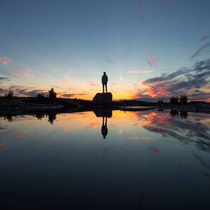 Preview wallpaper silhouette, rock, alone, water, reflection