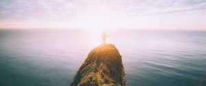 Preview wallpaper silhouette, rock, sunset, sea, sunlight, cliff