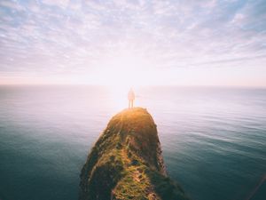 Preview wallpaper silhouette, rock, sunset, sea, sunlight, cliff