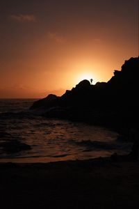 Preview wallpaper silhouette, rock, sunset, water, shore