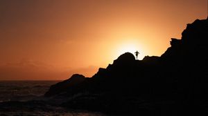 Preview wallpaper silhouette, rock, sunset, water, shore