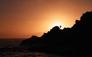 Preview wallpaper silhouette, rock, sunset, water, shore