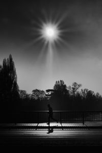 Preview wallpaper silhouette, running, bridge, bw, sunlight