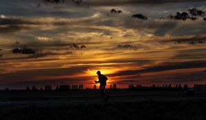 Preview wallpaper silhouette, running, sunset, athlete, clouds, sky
