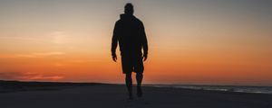 Preview wallpaper silhouette, sand, footprints, beach, sea, sunset, twilight