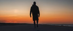 Preview wallpaper silhouette, sand, footprints, beach, sea, sunset, twilight