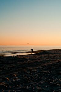 Preview wallpaper silhouette, sea, coast, sunset, sand