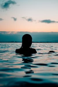 Preview wallpaper silhouette, sea, sunset, swimming, ripples