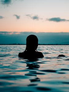 Preview wallpaper silhouette, sea, sunset, swimming, ripples