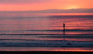 Preview wallpaper silhouette, sea, waves, sunset