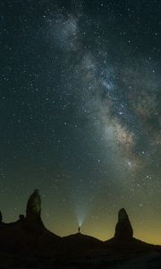 Preview wallpaper silhouette, starry sky, night, flashlight, rocks