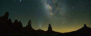 Preview wallpaper silhouette, starry sky, night, flashlight, rocks