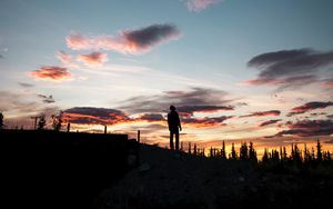 Preview wallpaper silhouette, sunset, solitude, clouds, hill, healy, united states