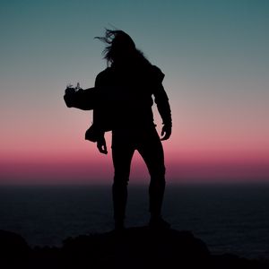 Preview wallpaper silhouette, wind, man, sunset, night