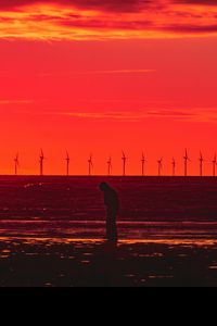 Preview wallpaper silhouette, wind turbines, sunset, horizon, red