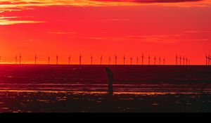 Preview wallpaper silhouette, wind turbines, sunset, horizon, red