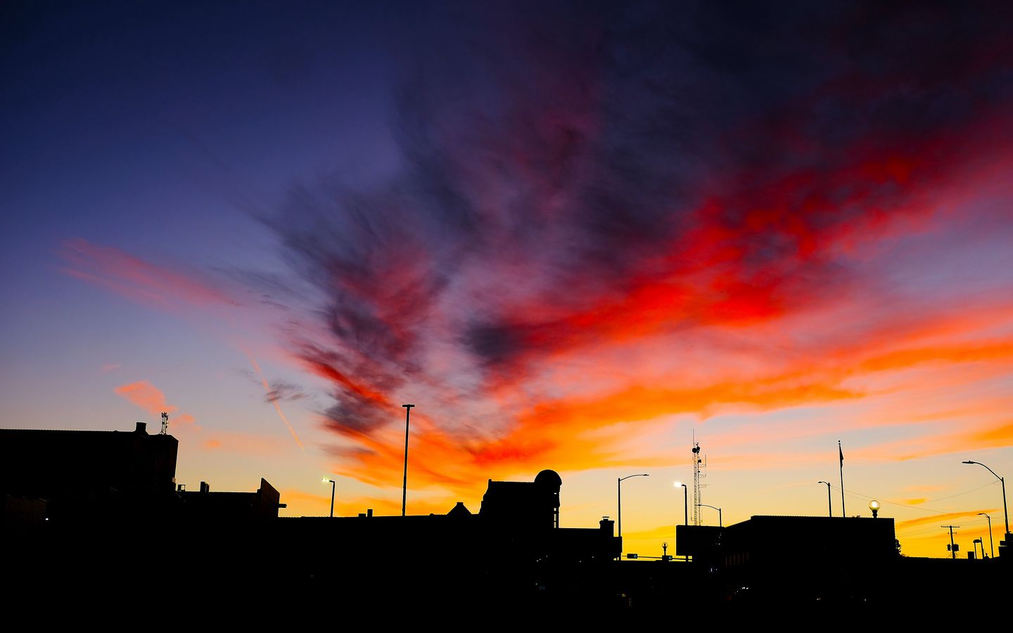 1440x900 Wallpaper silhouettes, city, buildings, clouds, colorful, sunset, sky, dark