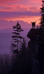 Preview wallpaper silhouettes, cliff, sunset, mountains, trees