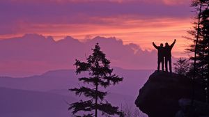 Preview wallpaper silhouettes, cliff, sunset, mountains, trees