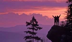 Preview wallpaper silhouettes, cliff, sunset, mountains, trees