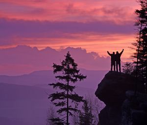 Preview wallpaper silhouettes, cliff, sunset, mountains, trees