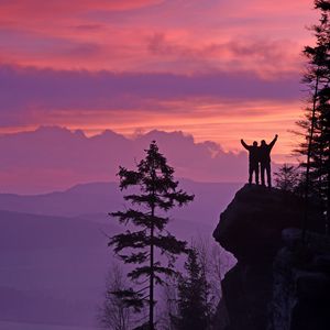 Preview wallpaper silhouettes, cliff, sunset, mountains, trees
