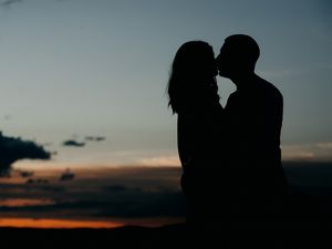 Preview wallpaper silhouettes, kiss, couple, love, hugs, romance, night