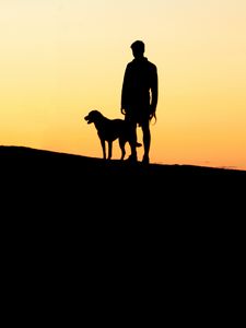 Preview wallpaper silhouettes, man, dog, sunset, hill