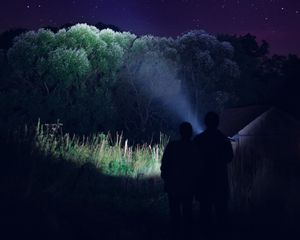 Preview wallpaper silhouettes, night, dark, flashlight, trees, light