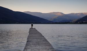 Preview wallpaper silhouettes, pier, lake, water, mountains, nature