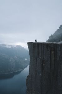 Preview wallpaper silhouettes, rock, cliff, lake, mist