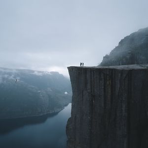 Preview wallpaper silhouettes, rock, cliff, lake, mist