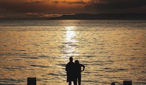 Preview wallpaper silhouettes, sunset, couple, sea, horizon